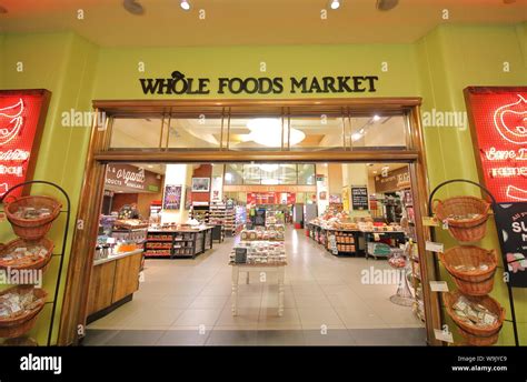 People Visit Whole Foods Market In Kensington High Street London Uk