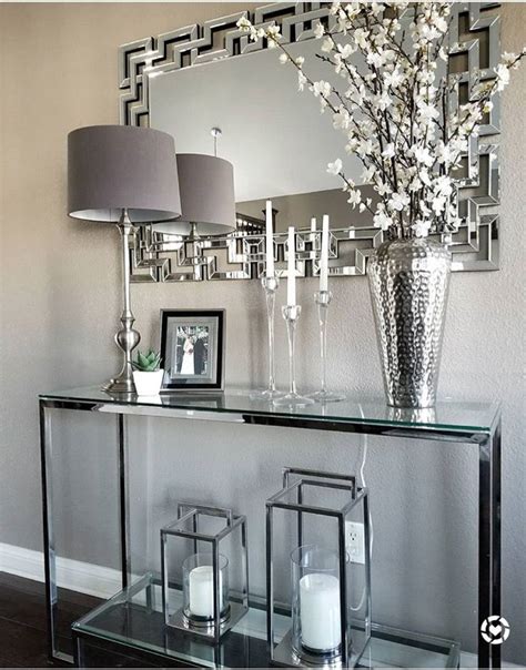 It will become a place of mail, of items you need to remember to take to work, and of fresh flowers to welcome you home at the end of the day. Glass console, mirrored finishes, entry styling ...