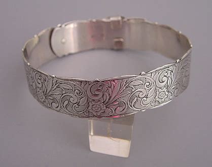 Gold tone engraved hinged bangle bracelet. Morning Glory Antiques & Jewelry