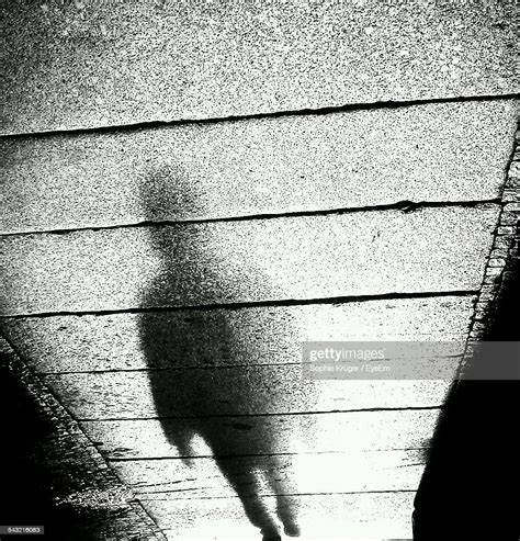 Shadow Of Man On Sidewalk Stock Photo Getty Images