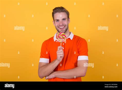 Sweet That Speaks Sweet Tooth Yellow Background Happy Man Hold Candy On Stick Sweet Snack