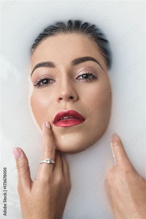 Fashion Model Girl Taking Milk Bath Beauty Young Woman With Bright Makeup Relaxing In Bath Spa
