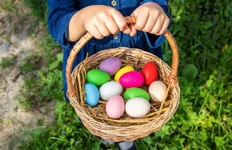 Premium Photo The Child Holds Easter Eggs In His Hands Selective Focus