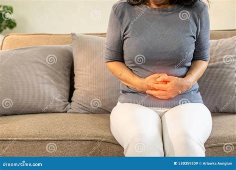 Asian Old Woman Sitting On Sofa With Stomach Ache Irritable Bowel