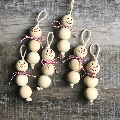 Christmas ornaments kids can make with beads and wire. Wood Bead Snowman Ornaments | Christmas ornaments, Christmas ornament crafts, Christmas crafts
