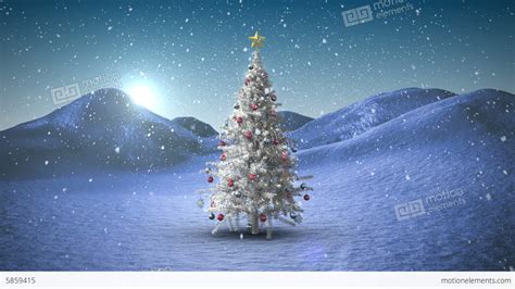 Snow Falling On Christmas Tree In Snowy Landscape Stock