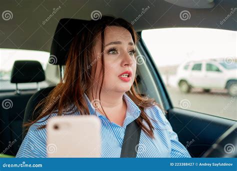 The Sad Woman Driving The Car Drives The Car And Speaks On The Phone