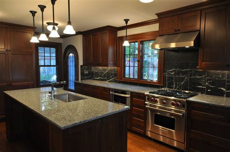 This kitchen looks so elegant and modern black cherry cabinets. 10 Black wood Kitchen Cabinets Designs