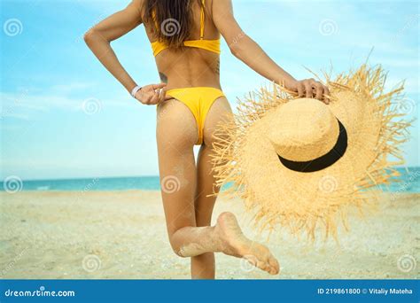Tanned Slim Body Woman In Bikini Walking On Sand Beach Holding Straw