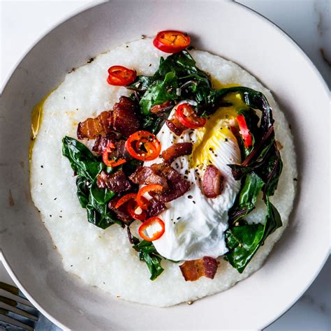 Cheesy Grits With Poached Eggs Greens And Bacon Recipe Bon Appétit