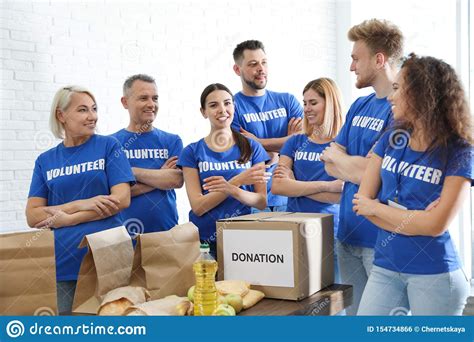 Team Of Volunteers Near Table With Food Donations Stock Photo Image