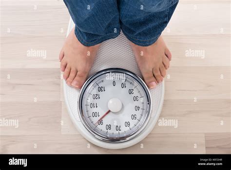 Person Standing On Weighing Scale Stock Photo Alamy