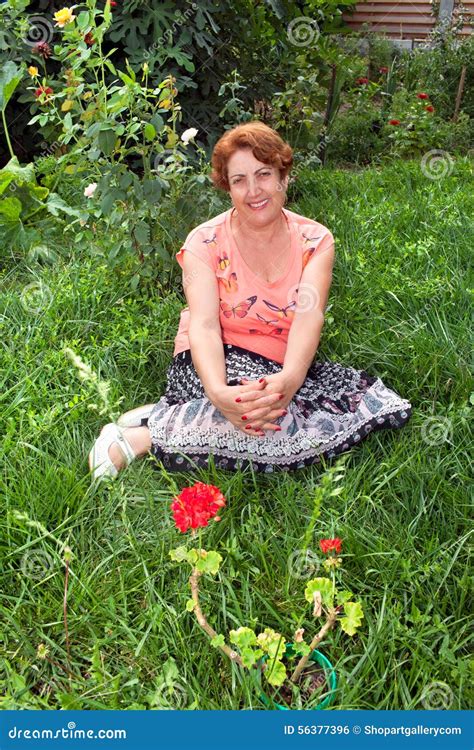 Happy Senior Woman Sitting In The Grass Stock Photo Image Of Nature