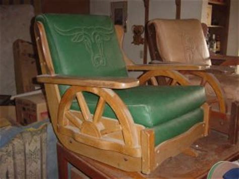 Upholstered in authentic, genuine naugahyde, the rocky mountain scene teams up well with the wagon wheel armrests. chair antiques