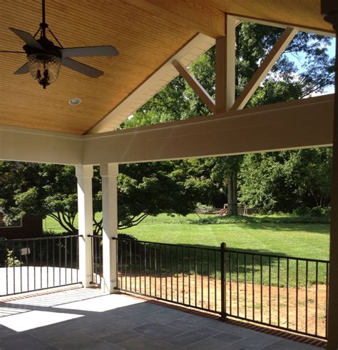 Here, both patios and porches may be paved outdoor living spaces appointed with outdoor furniture. Covered Porch in Raleigh over a Limestone patio | House ...