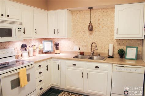 This gray and white family kitchen has touches of gold and warm accents. Kitchen Transformation: White Cabinets & Painted Counters with White Appliances - Project Goble