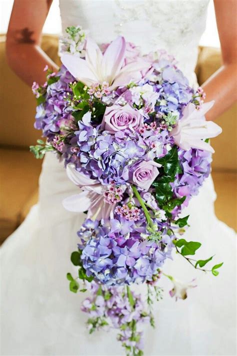 Beautiful Cascading Bridal Bouquet Which Is Arranged With Purple Jumbo