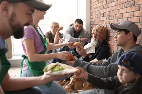 Volunteers Giving Food To Poor People The Concept Of Food Sharing Help Solve Hunger For The