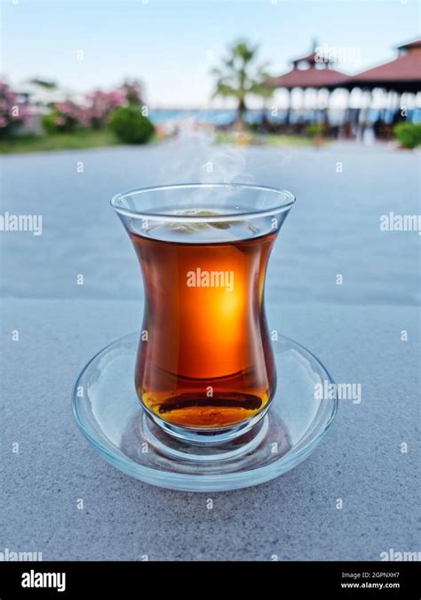Turkish Tea Served In Tulip Shaped Glass On A Small Saucer Blurred