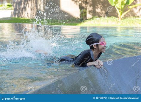 Asian Girl Is Floating And Splashing Water With Their Legs On Th Stock