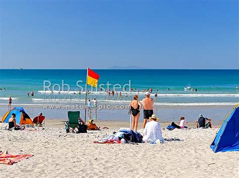 Mount Maunganui Summer Beach Panorama With Swimmers And Sunbathers Surflifesaving Flags Visible