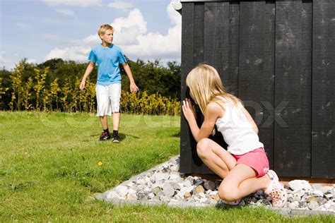 A Brother And Sister Playing Hide And Seek Stock Image Colourbox