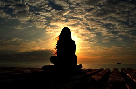 Silhouette Of A Girl Sitting In The Lotus Position Closed