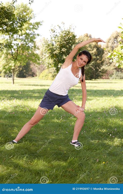Young Woman Doing Stretching Exercise On Grass Stock Image Image Of