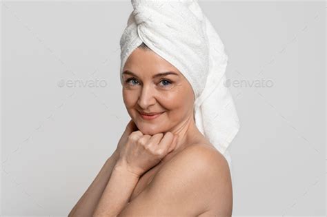 Portrait Of Attractive Nude Middle Aged Woman With Towel On Head Stock