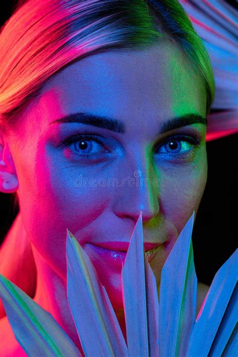 High Fashion Model In Colorful Bright Neon Lights Posing At Studio