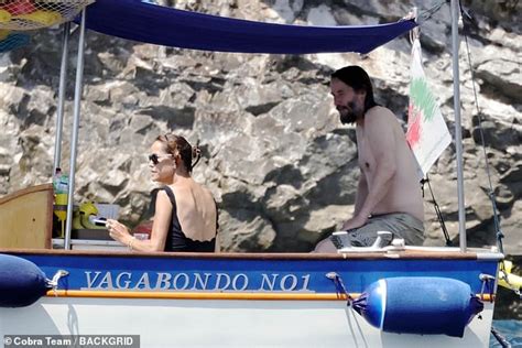 Shirtless Keanu Reeves Enjoys Boat Day With A Glass Of Champagne As John Wick Star Holidays In