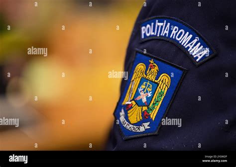 The Coat Of Arms Of The Romanian Police On The Uniform Of A Romanian
