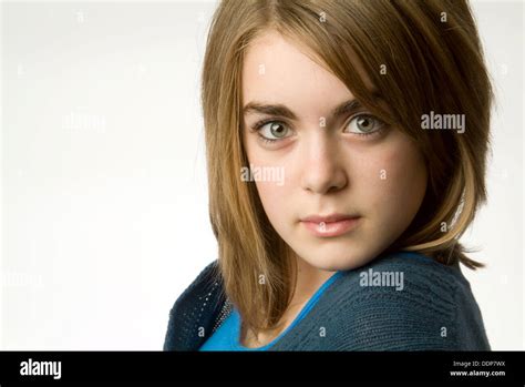 Thirteen Year Old Girl In Studio White Background Headshot Serious