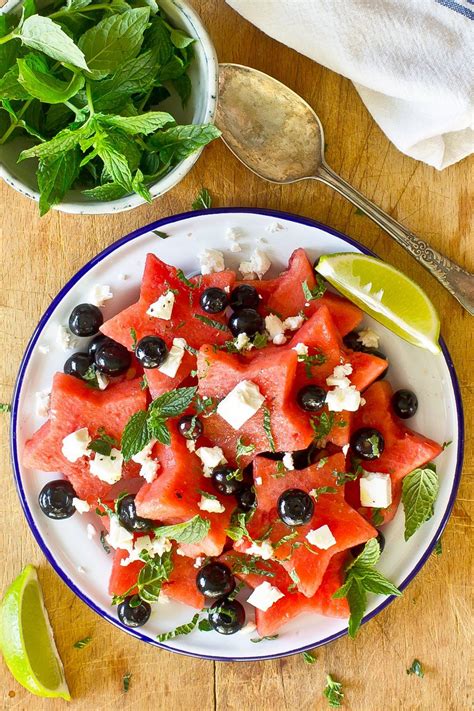 Watermelon Salad With Feta Cheese And Black Olives On A White Plate