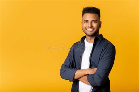 Confident Young Indian Man Standing In Confident Pose With Arms Crossed Looking At Camera Stock