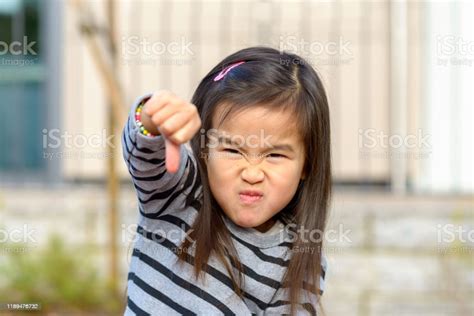Angry Little Asian Girl Punching At The Camera Stock Photo Download