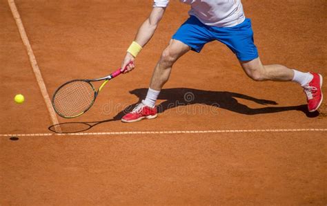 Male Tennis Player In Action On The Court On A Sunny Day Stock Image