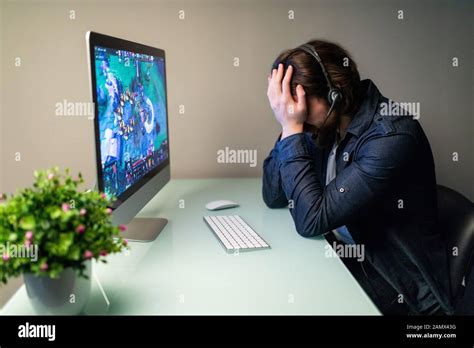 Young Gamer Playing Online Video Games On Computer And Feel Depressed