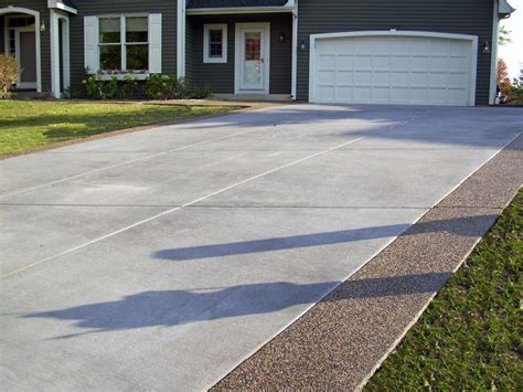 Gray Brushed Concrete Driveway With Exposed Aggregate Borders