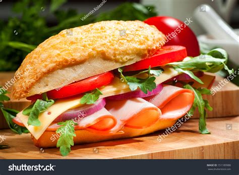 Gourmet Sandwich With Ham Cheese Fresh Tomatoes Salad And A White