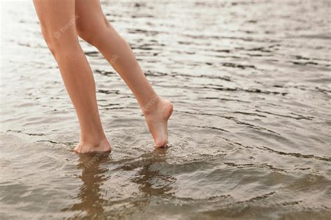 Premium Photo Close Up Naked Slim Woman Legs Walking Barefoot Along The River Female Feet On