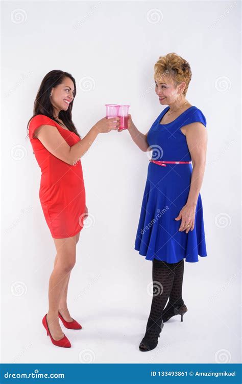 Full Body Shot Profile View Of Happy Senior Asian Woman And Youn Stock