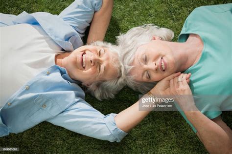 Older Caucasian Lesbian Couple Laying In Grass Photo Getty Images