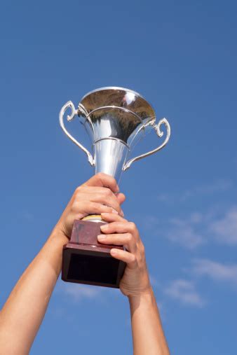 Arms Raising The Winning Trophy Stock Photo Download Image Now Istock