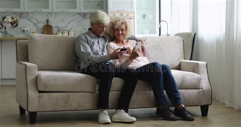 mature wife showing pictures to her husband stock footage video of iphone looking 257851138