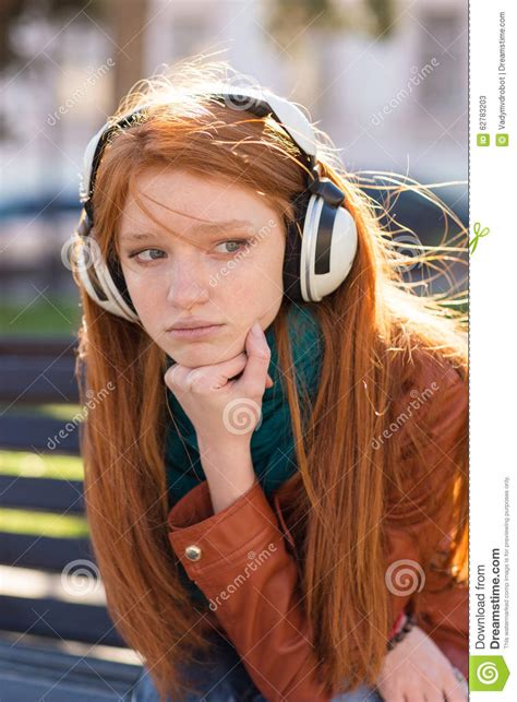 Portrait Of Beautiful Sad Pensive Young Woman In Earphones Stock Image