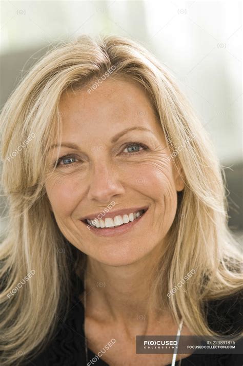 Portrait Of Blond Mature Woman Smiling On Blurred Background Hairstyle Healthy Stock Photo
