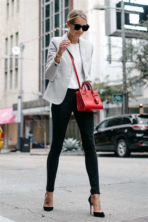 blonde woman wearing grey blazer white top black skinny jeans black pumps saint laurent sac de