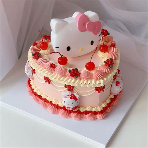 A Hello Kitty Cake With Cherries On Top