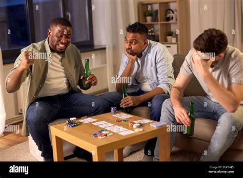 Male Friends Playing Cards At Home At Night Stock Photo Alamy